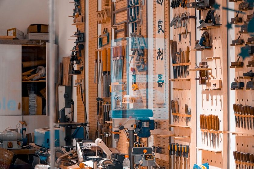 An old pegboard with worn, mismatched hook positions