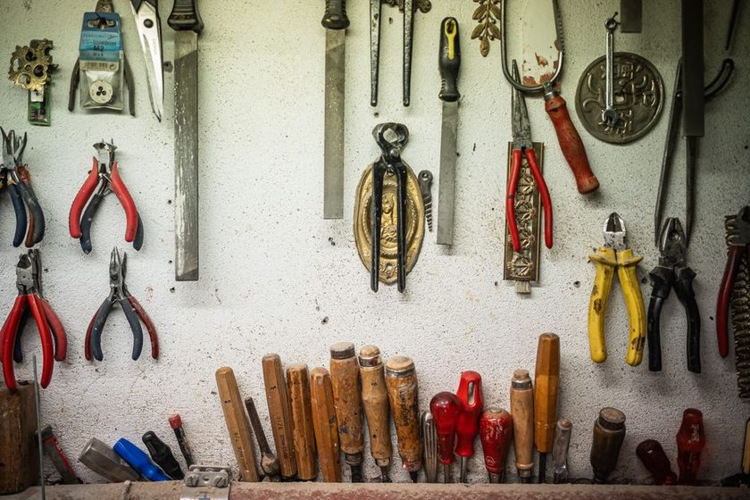 Empty painted outline on a pegboard where a tool is missing