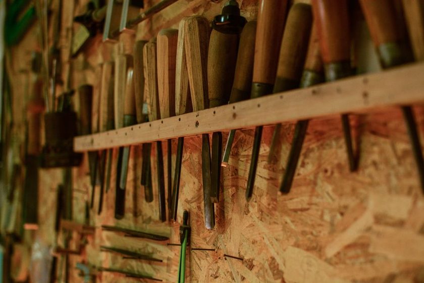 A person pausing in front of an empty tool outline, searching